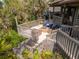 Elevated deck showcasing outdoor furniture and a fire pit, perfect for enjoying the natural surroundings at 1296 Weybridge Ln, Dunedin, FL 34698