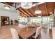 Open-concept dining room featuring a high ceiling, wood beams, and ample natural light at 1296 Weybridge Ln, Dunedin, FL 34698