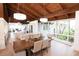Spacious dining area with wood ceiling and trim, with views to outdoors and kitchen at 1296 Weybridge Ln, Dunedin, FL 34698