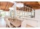 Bright dining area with vaulted wood ceiling and modern lighting adjacent to kitchen at 1296 Weybridge Ln, Dunedin, FL 34698