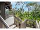 Exterior stairs leading to the house surrounded by trees, showcasing outdoor living at 1296 Weybridge Ln, Dunedin, FL 34698