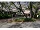 Charming exterior view of home featuring mature landscaping and a spacious driveway at 1296 Weybridge Ln, Dunedin, FL 34698