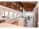 Bright kitchen featuring white cabinets, island cooktop, and breakfast nook with wood ceiling at 1296 Weybridge Ln, Dunedin, FL 34698