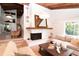 Bright living room features a fireplace, wood ceiling, and views of the outdoors at 1296 Weybridge Ln, Dunedin, FL 34698