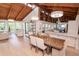Open-concept living area with wood vaulted ceiling, modern lighting, dining and views at 1296 Weybridge Ln, Dunedin, FL 34698