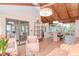 Bright living area with vaulted wood ceiling and modern lighting adjacent to dining and kitchen at 1296 Weybridge Ln, Dunedin, FL 34698