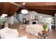 Inviting living space with fireplace, wood ceiling, and seamless flow to the dining area at 1296 Weybridge Ln, Dunedin, FL 34698