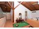 Bright living room with a loft, wood beams, pool table, and comfortable seating, perfect for entertaining at 1296 Weybridge Ln, Dunedin, FL 34698