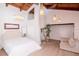 Bright main bedroom featuring high vaulted ceilings, wood beams, and elegant light fixtures at 1296 Weybridge Ln, Dunedin, FL 34698