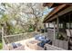 Inviting outdoor deck with comfortable seating around a cozy brick fire pit perfect for entertaining and enjoying the serene views at 1296 Weybridge Ln, Dunedin, FL 34698