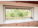 Cozy window seat with built-in storage and a scenic view of the lush, surrounding greenery at 1296 Weybridge Ln, Dunedin, FL 34698