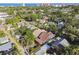 Aerial view of neighborhood homes with green trees and blue water in the distance at 135 12Th Ne Ave, St Petersburg, FL 33701