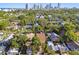 Aerial view of neighborhood homes, green trees, and the city skyline in the distance at 135 12Th Ne Ave, St Petersburg, FL 33701