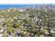 Aerial view of neighborhood, lush green trees, and city skyline with beautiful blue water views at 135 12Th Ne Ave, St Petersburg, FL 33701