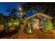 Charming backyard with a brick pathway and lush tropical greenery, leading to a quaint shed at 135 12Th Ne Ave, St Petersburg, FL 33701