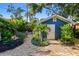 The backyard features a quaint detached garage with lush landscaping and brick walkway at 135 12Th Ne Ave, St Petersburg, FL 33701