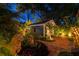 Backyard view with guest house, lush landscaping, and brick pathway with lighting at 135 12Th Ne Ave, St Petersburg, FL 33701