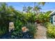 Secluded backyard featuring brick pavers, lush landscaping and a stone lion at 135 12Th Ne Ave, St Petersburg, FL 33701