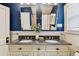 Bathroom features granite counters, dual sinks, blue walls, and dual mirrors at 135 12Th Ne Ave, St Petersburg, FL 33701