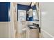 Bathroom with blue walls, granite countertop, and shower at 135 12Th Ne Ave, St Petersburg, FL 33701
