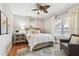Light-filled bedroom with hardwood floors, area rug, and chair at 135 12Th Ne Ave, St Petersburg, FL 33701