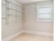 Walk-in closet boasts built-in shelving and tile flooring at 135 12Th Ne Ave, St Petersburg, FL 33701