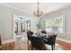 Bright dining room with hardwood floors and chandelier, adjacent to living room at 135 12Th Ne Ave, St Petersburg, FL 33701