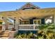 Charming blue home featuring a spacious front porch and beautifully landscaped yard at 135 12Th Ne Ave, St Petersburg, FL 33701