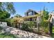 Charming blue two-story home with landscaped front yard and black metal fence at 135 12Th Ne Ave, St Petersburg, FL 33701