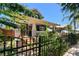 Charming blue two-story home with landscaped front yard and black metal fence at 135 12Th Ne Ave, St Petersburg, FL 33701