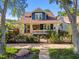 Charming blue two-story home with a welcoming front porch and meticulously landscaped front yard at 135 12Th Ne Ave, St Petersburg, FL 33701