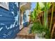Charming blue home featuring brick pathway and lush tropical landscaping at 135 12Th Ne Ave, St Petersburg, FL 33701