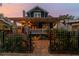 Charming home exterior featuring a covered porch, landscaped yard and a wrought iron fence at 135 12Th Ne Ave, St Petersburg, FL 33701