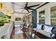Covered front porch with seating, ceiling fan, and classic architectural details at 135 12Th Ne Ave, St Petersburg, FL 33701