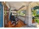 Inviting front porch features a ceiling fan, rocking chair, and charming accents at 135 12Th Ne Ave, St Petersburg, FL 33701
