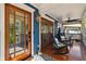 Inviting front porch with wood floors, seating and glass doors at 135 12Th Ne Ave, St Petersburg, FL 33701