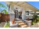 Charming blue home featuring a spacious front porch with brick steps and lion statues at 135 12Th Ne Ave, St Petersburg, FL 33701