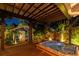 Relaxing outdoor area featuring hot tub, covered patio, seating, tropical landscaping and guest house at 135 12Th Ne Ave, St Petersburg, FL 33701
