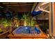 Inviting backyard hot tub with wooden deck and tropical landscaping creating a serene outdoor oasis at 135 12Th Ne Ave, St Petersburg, FL 33701