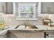 Close up of a kitchen sink with stone countertop, and a window at 135 12Th Ne Ave, St Petersburg, FL 33701