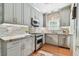 Bright kitchen featuring gray cabinets, stone countertops, and stainless steel appliances at 135 12Th Ne Ave, St Petersburg, FL 33701