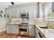Well-lit kitchen showcasing gray cabinets, stone countertops, and stainless steel oven at 135 12Th Ne Ave, St Petersburg, FL 33701