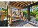 Covered outdoor patio features a cozy daybed with decorative pillows and tropical landscaping at 135 12Th Ne Ave, St Petersburg, FL 33701