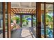 Inviting covered patio featuring a daybed and views of the landscaped backyard and detached garage at 135 12Th Ne Ave, St Petersburg, FL 33701