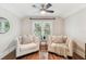 Sitting area boasts hardwood floors, a ceiling fan and two chairs at 135 12Th Ne Ave, St Petersburg, FL 33701