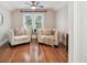 Sitting area boasts hardwood floors, a ceiling fan and two chairs at 135 12Th Ne Ave, St Petersburg, FL 33701