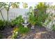 Landscaped backyard featuring a tiered fountain surrounded by a mulched garden with mature plants at 13511 Avista Dr, Tampa, FL 33624