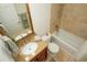 Neutral bathroom with tiled shower-tub, granite vanity, and wood framed mirror at 13511 Avista Dr, Tampa, FL 33624