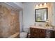 Well-lit bathroom with tiled shower, dark wood vanity, and modern fixtures at 13511 Avista Dr, Tampa, FL 33624