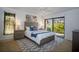 Well-lit main bedroom with a ceiling fan, neutral walls, and access to the outdoors at 13511 Avista Dr, Tampa, FL 33624